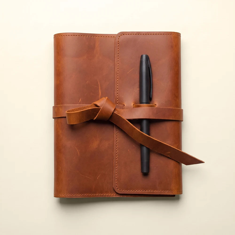 Leather planner organizer with multiple pockets and sturdy pen carrying loop.