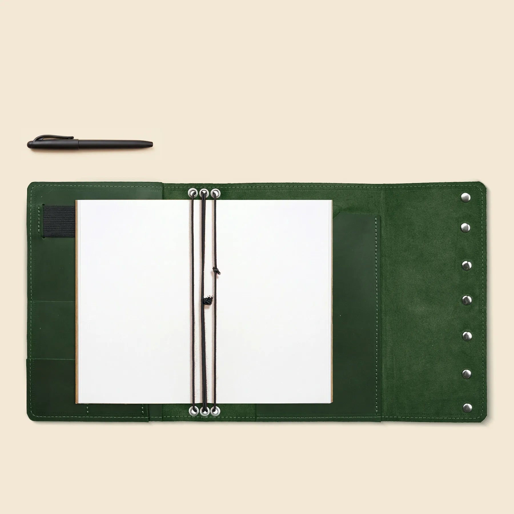 Handmade leather notebook organizer with pen holder and card storage.