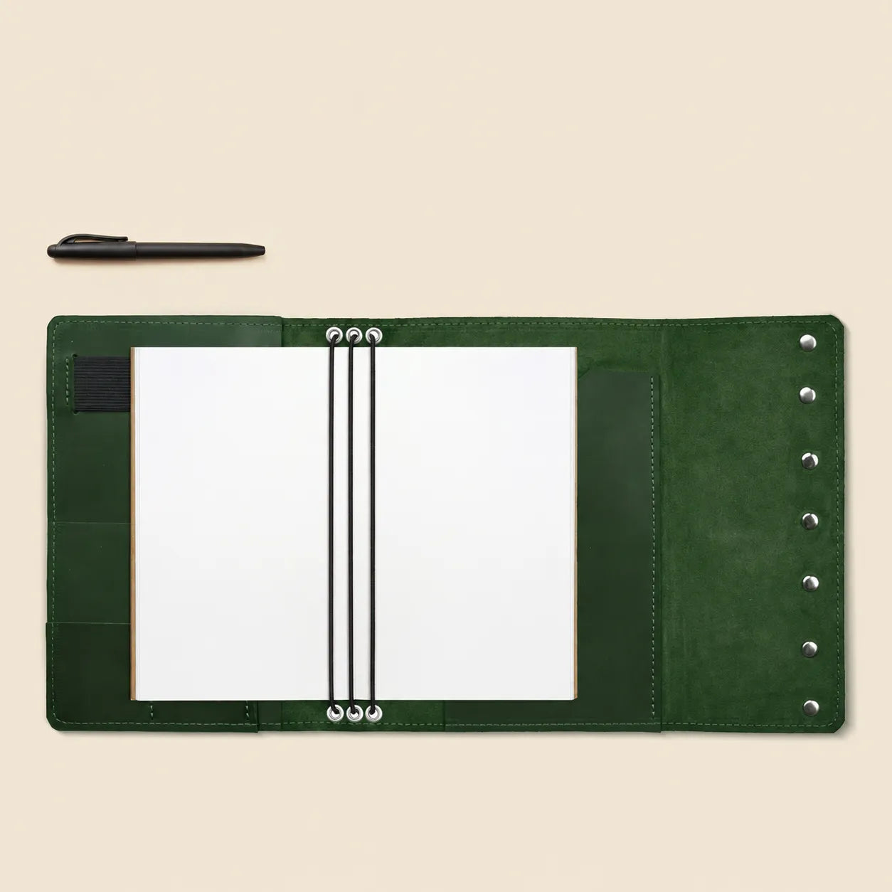 Refillable genuine leather journal cover with practical storage pockets and pen holder.