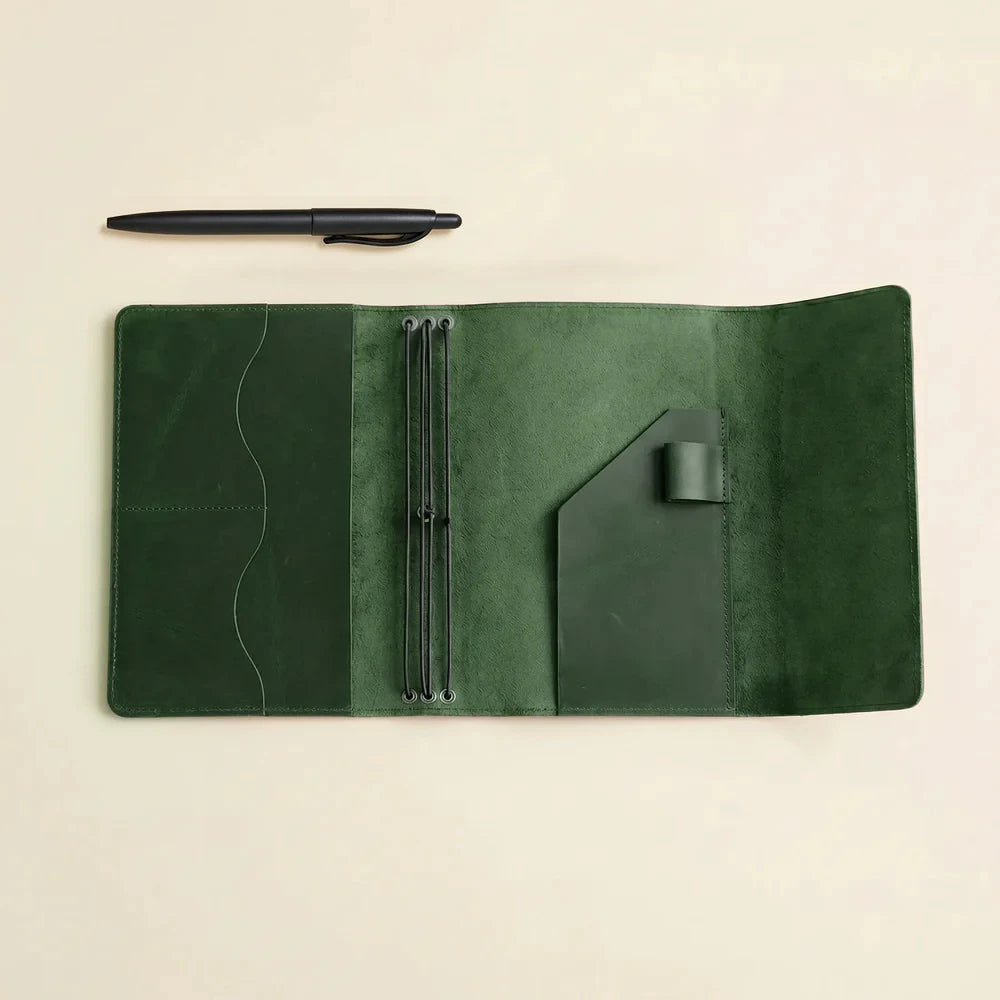 Handmade leather notebook organizer with multiple elastic bands and convenient storage compartments.