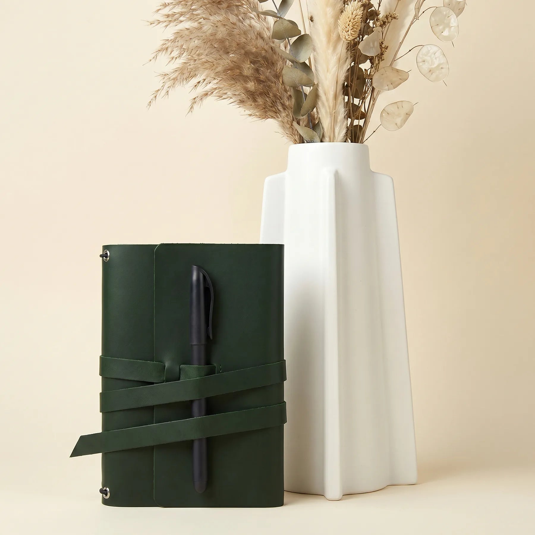 Premium leather notebook holder with integrated pen loops for office and travel use.