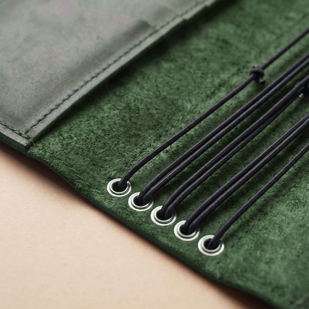 Leather notebook carrier featuring inner sleeves and elastic retention