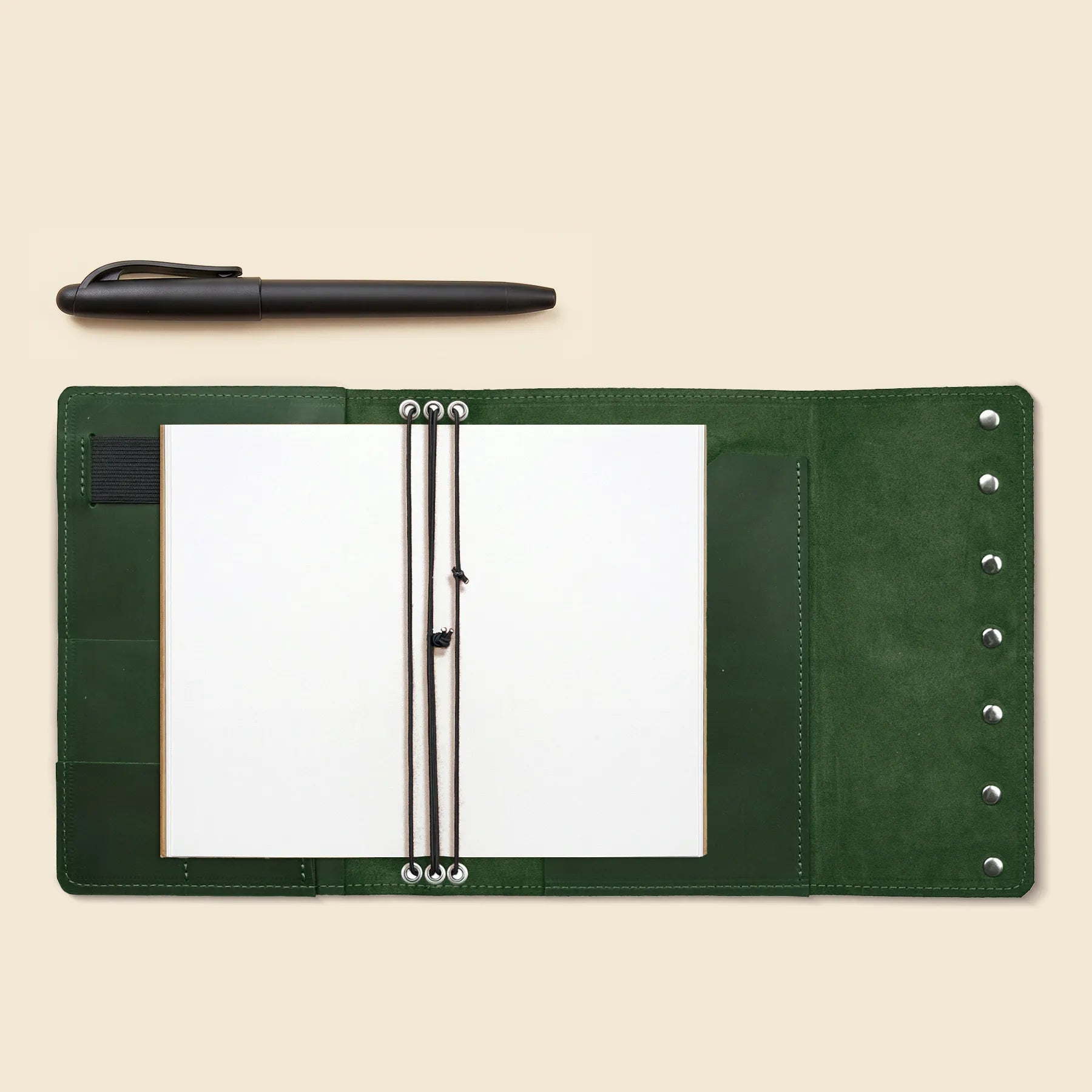 Leather travel journal cover with card slots and three elastic inserts.
